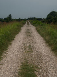 Empty road along countryside landscape