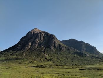 Scenic view of rocky mountains against clear blue sky