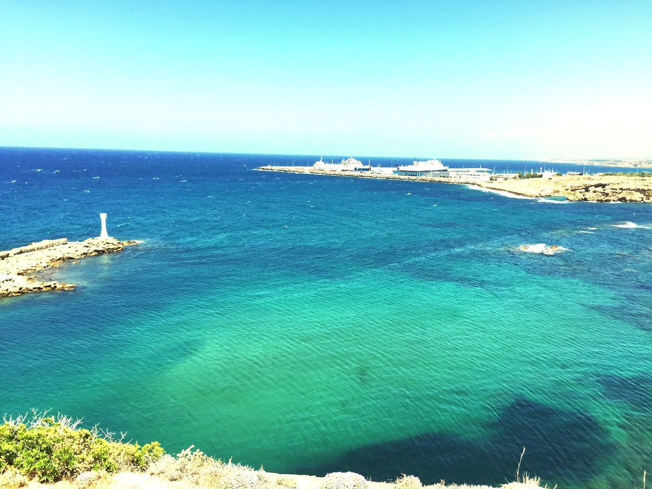 sea, water, horizon over water, blue, clear sky, tranquil scene, scenics, tranquility, beauty in nature, copy space, nature, beach, nautical vessel, high angle view, seascape, coastline, idyllic, transportation, day, shore