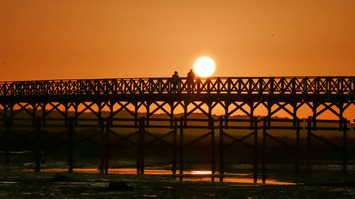 Silhouette of bridge at sunset