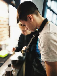 Owner holding cup at cafe