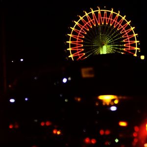 Low angle view of illuminated ferris wheel