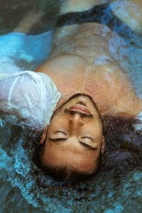 Close-up portrait of a man lying in water