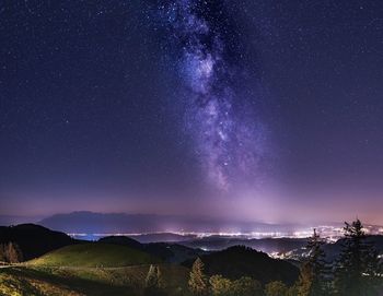 Scenic view of landscape against sky at night