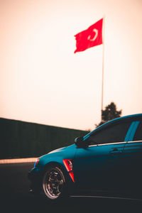 Red flag on road against clear sky