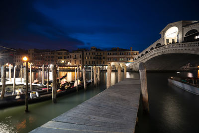 Bridge over canal in city at night