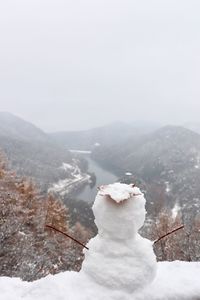 Scenic view of snow covered mountains against sky