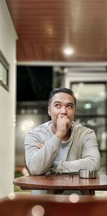 Portrait of a man sitting on table