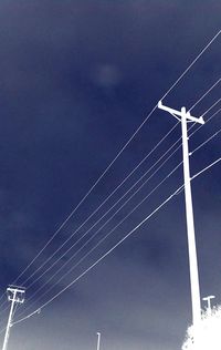 Low angle view of telephone pole against sky