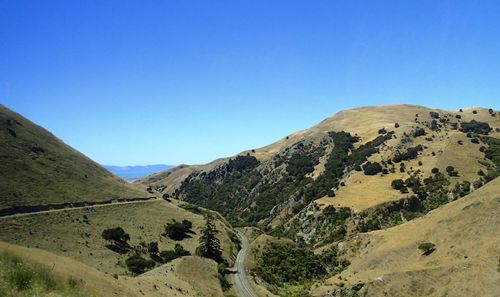 Scenic view of mountains against clear blue sky