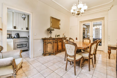 Empty chairs and tables and table and potted plant on floor at home