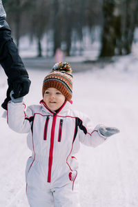 Portrait of boy standing on snow