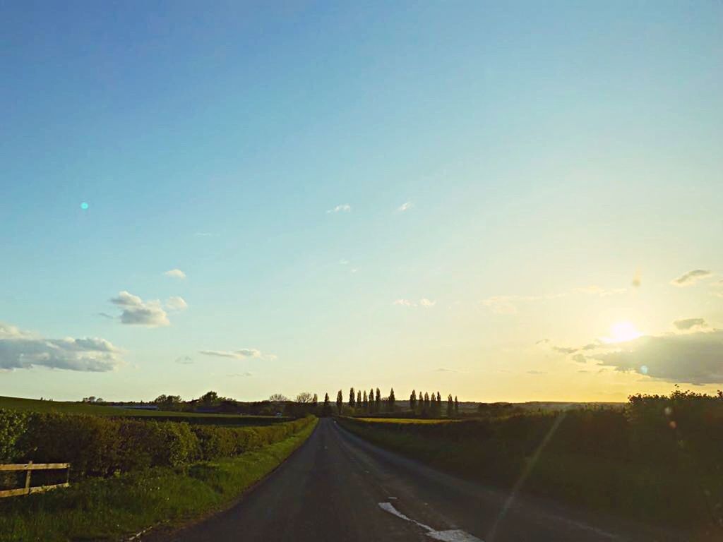 sky, road, transportation, the way forward, direction, nature, landscape, no people, cloud - sky, environment, diminishing perspective, country, sunset, vanishing point, symbol, road marking, country road, sunlight, city, field, outdoors, dividing line