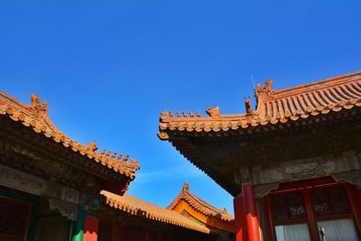 Low angle view of building against clear blue sky