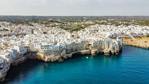 High angle view of townscape by sea against sky