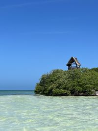 Scenic view of sea against clear blue sky