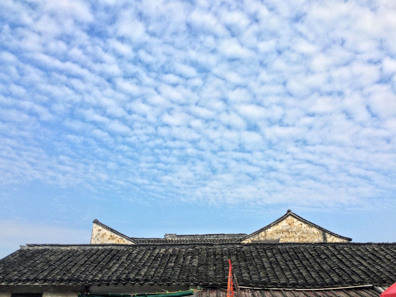 architecture, built structure, building exterior, roof, sky, day, low angle view, house, cloud - sky, no people, outdoors, tiled roof