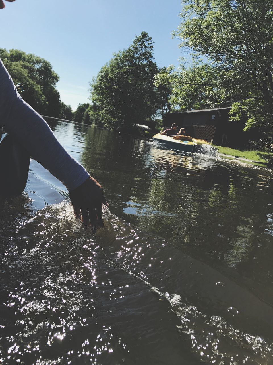 MAN ON RIVER AGAINST TREES