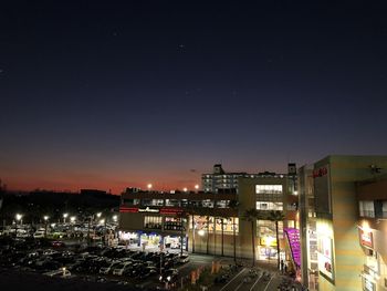 High angle view of illuminated buildings against sky at night