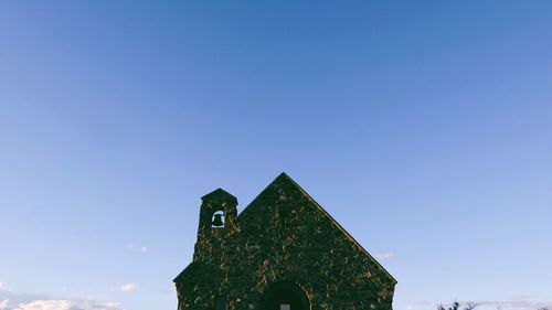 Low angle view of building against clear blue sky