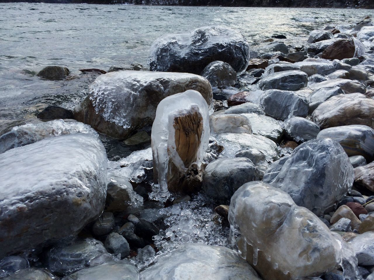 water, rock - object, nature, stone - object, motion, rock, beauty in nature, sea, surf, flowing water, stone, tranquility, day, shore, splashing, river, scenics, outdoors, rock formation, wave