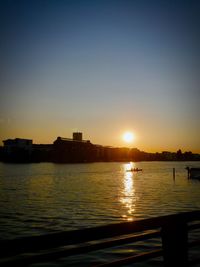 Scenic view of river against clear sky during sunset