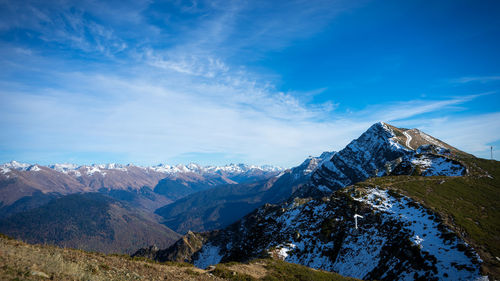 Scenic view of snowcapped mountains against blue sky