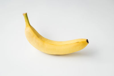 Close-up of yellow fruit against white background