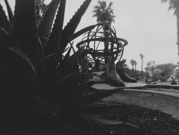 Close-up of sculpture on tree against sky