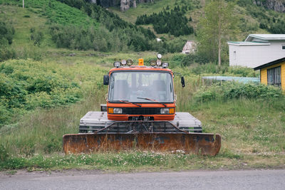 Truck on road amidst trees on field