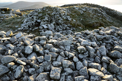 Stones on beach against sky