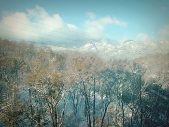 Scenic view of mountains against cloudy sky