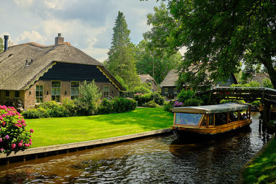 Gazebo by river against trees