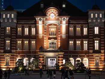 Group of people in front of building at night