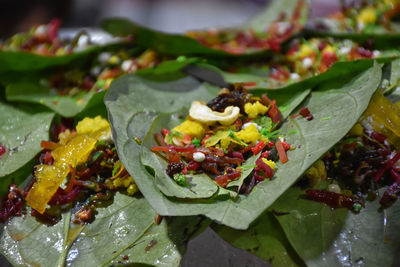 Close-up of fruits and leaves on plate