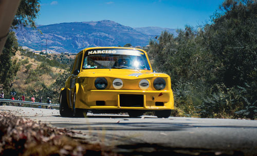 Yellow car on mountain road