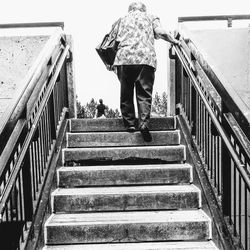 Low section of woman walking on stairs