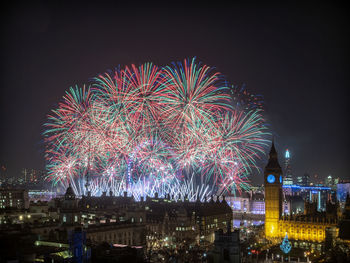 Low angle view of firework display at night