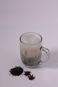 Close-up of drink on table against white background