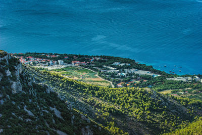 High angle view of buildings by sea against sky