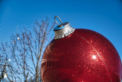 A giant christmas tree ornament in a public park