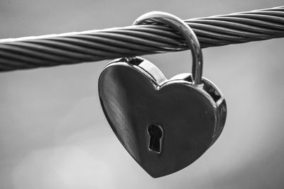 Close-up of heart shape hanging on metal