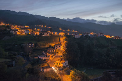 High angle view of illuminated buildings in city at night