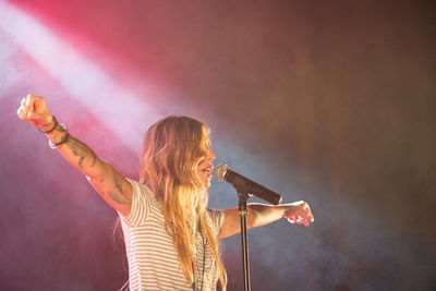 Rear view of young woman at music concert