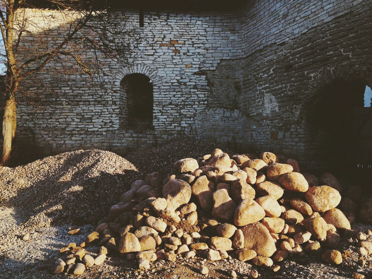 built structure, architecture, reflection, stone - object, water, stone wall, rock - object, abandoned, old, connection, wall - building feature, damaged, day, no people, puddle, outdoors, stone, brick wall, deterioration, stone material