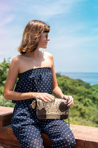 Girl holding a bag made of handmade python skin