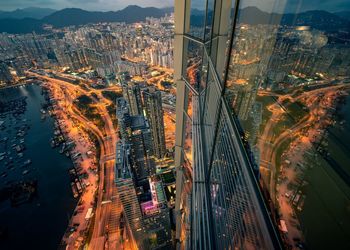 High angle view of illuminated street amidst buildings in city