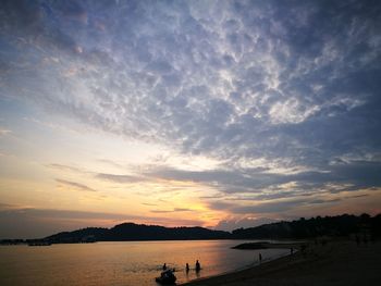 Scenic view of beach against sky during sunset