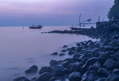 Scenic view of sea against sky at sunrise during blue hour