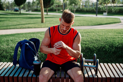 Man sitting on bench in park